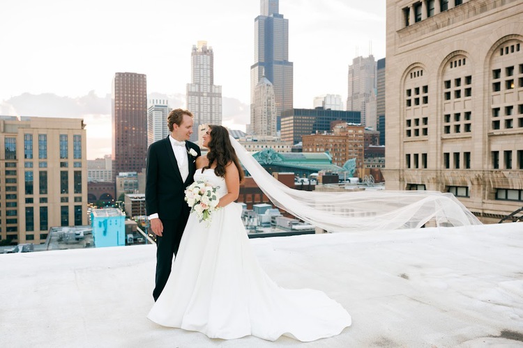 Wedding couple on rooftop with Chicago skyline