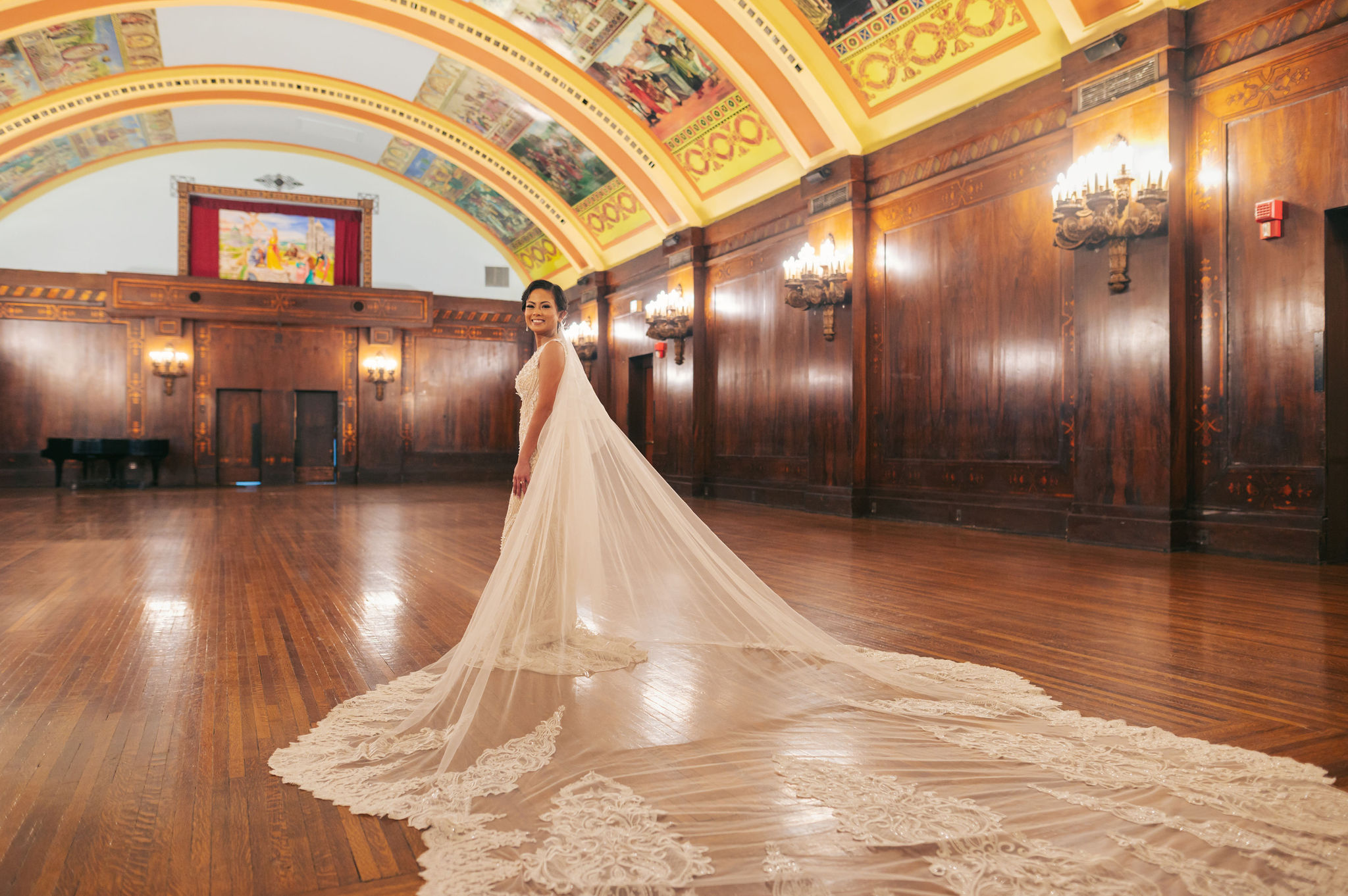 Bride with long veil in ballroom